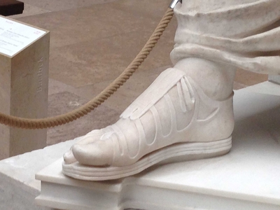 Photo of the sandals on a marble statue