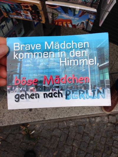 Postcard translates to: Good girls go to heaven, bad girls go to BERLIN