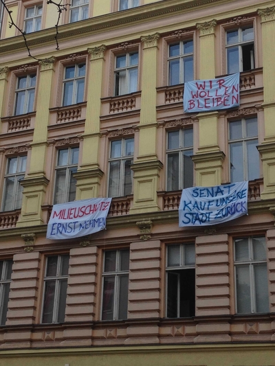 Protest signs hanging from apartment windows
