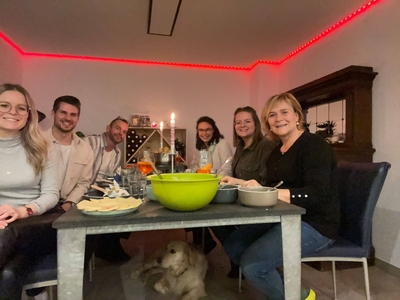 Louisa's mom's family at the dinner table eating raclette