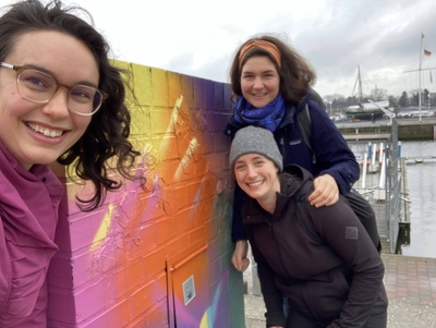 Kate Maggie and Mara by some colorful bricks by the harbor